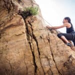 A woman goes rock-climbing.